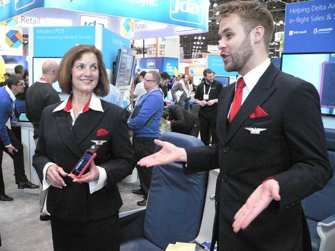 Delta flight attendants demonstrate Dynamics Retail Point-Of-Sale capabilities supported on Windows Phones.